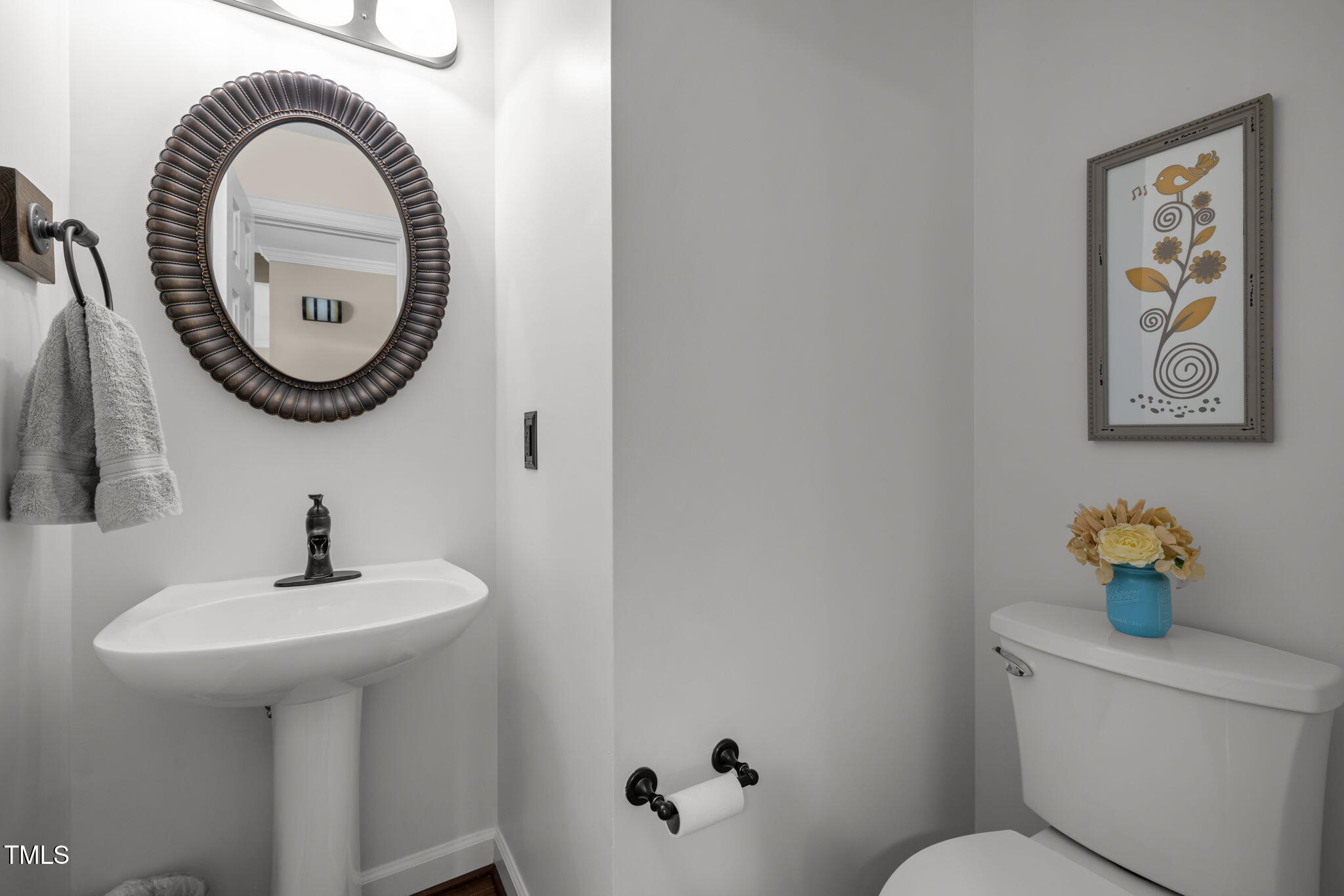 5909 Stable Court Raleigh, NC 27612 - Photo 22 of 45 a bathroom with a toilet a sink and a mirror