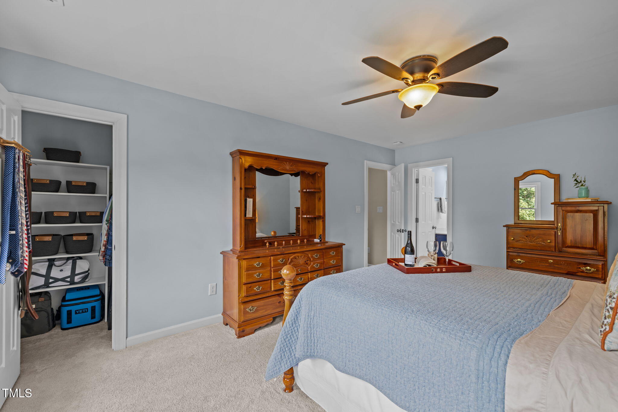 5909 Stable Court Raleigh, NC 27612 - Photo 26 of 45 a bedroom with a bed and a chandelier