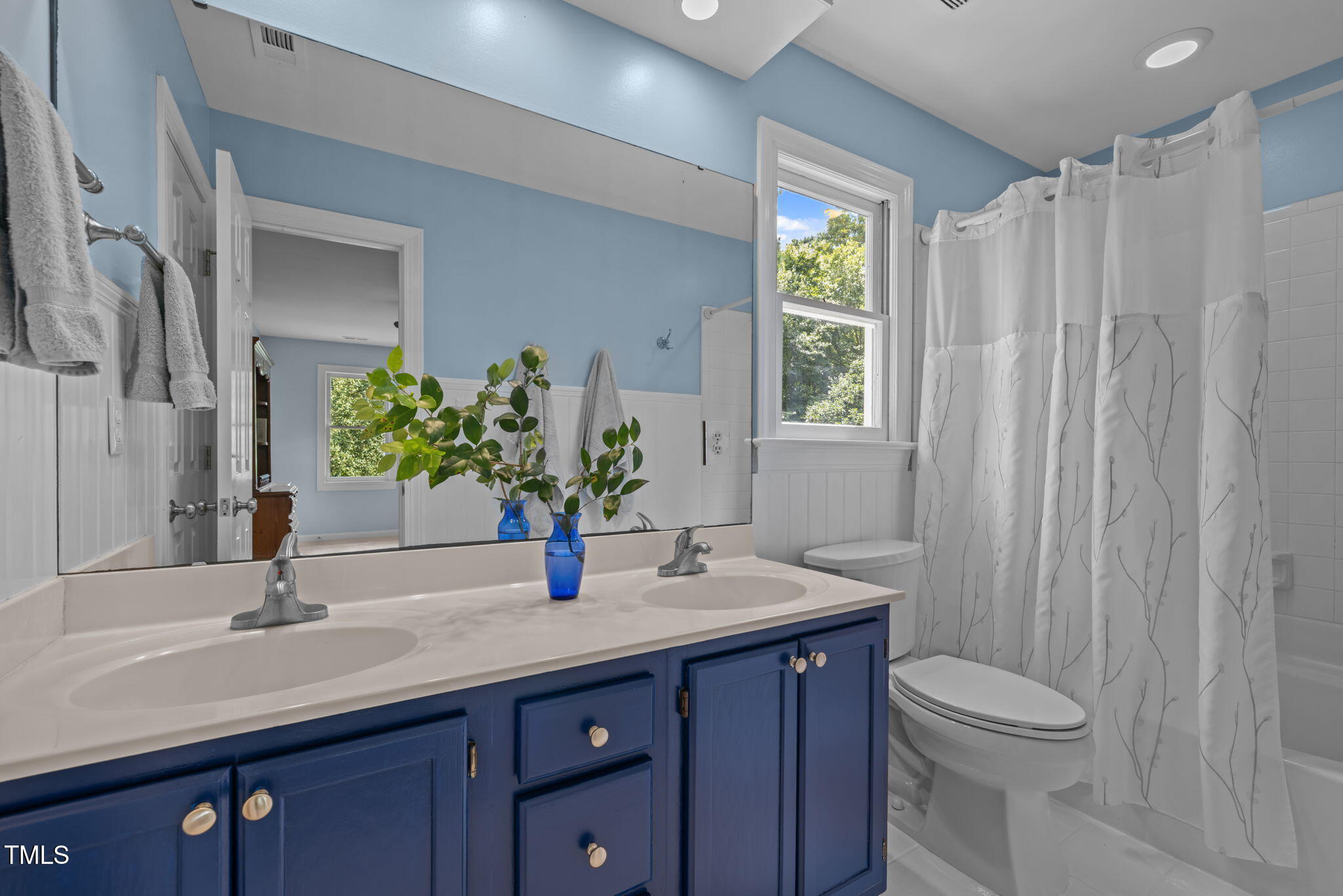 5909 Stable Court Raleigh, NC 27612 - Photo 27 of 45 a bathroom with a granite countertop sink toilet and mirror