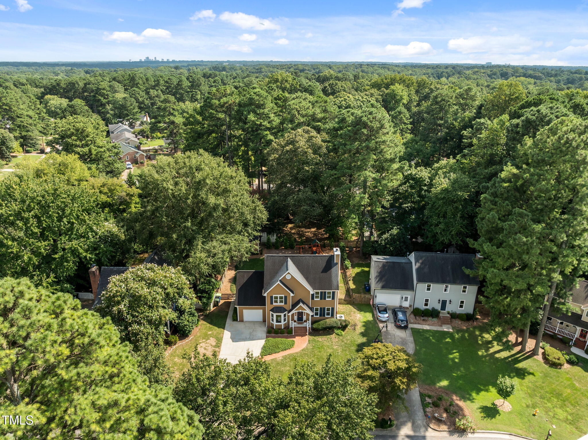 5909 Stable Court Raleigh, NC 27612 - Photo 2 of 45 a view of a house with a garden and trees