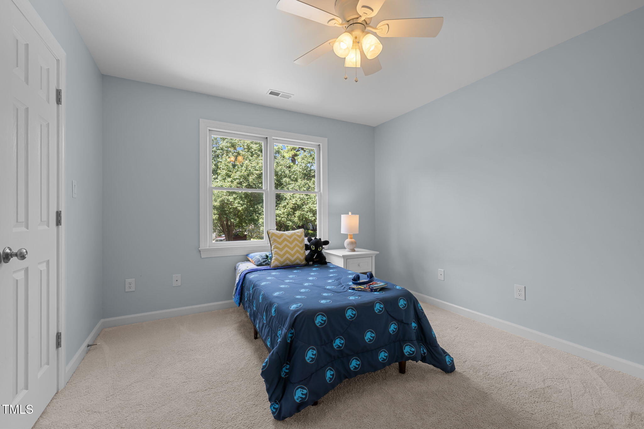5909 Stable Court Raleigh, NC 27612 - Photo 30 of 45 a bedroom with a bed and a chandelier