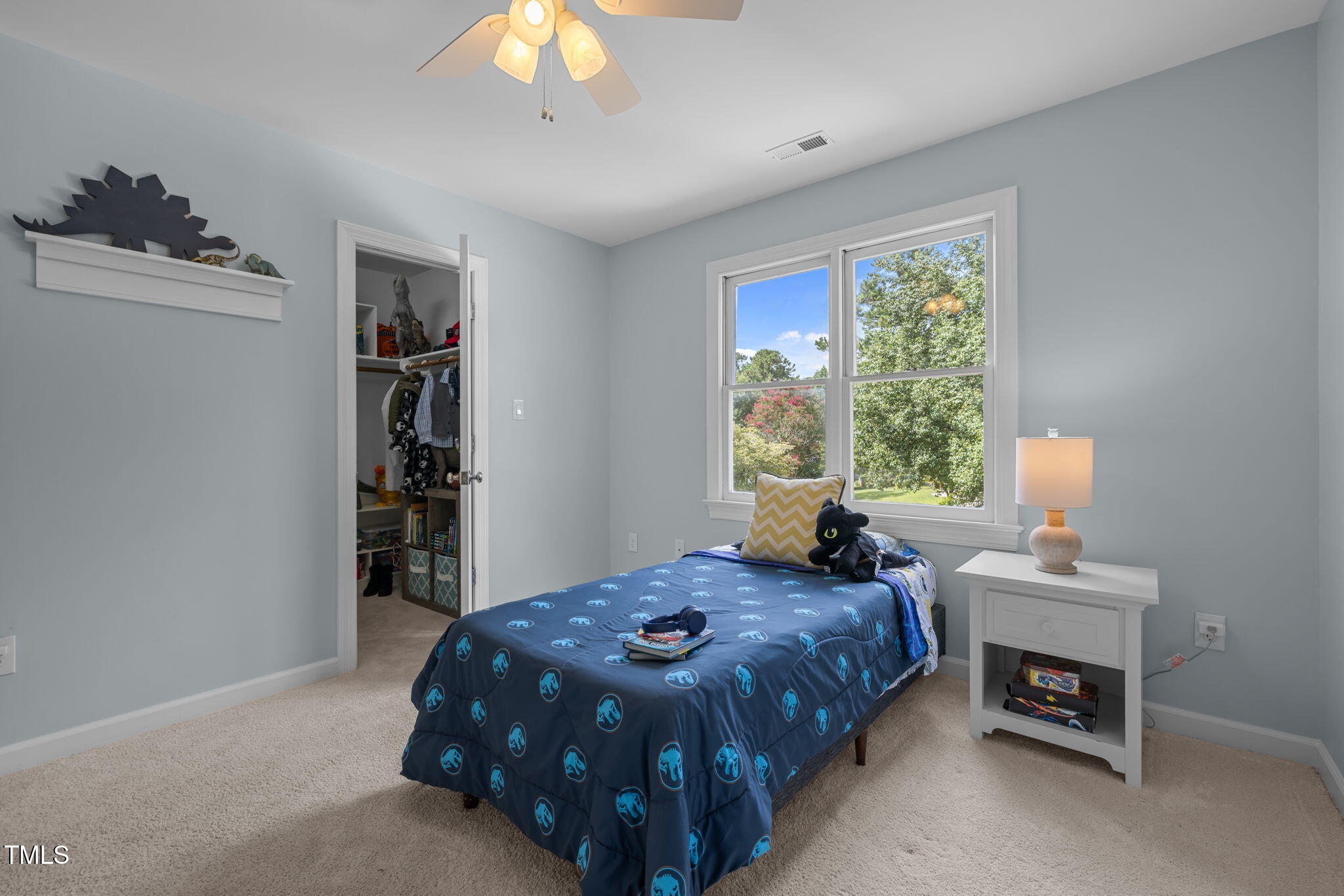 5909 Stable Court Raleigh, NC 27612 - Photo 31 of 45 a bedroom with a bed a table and a large window
