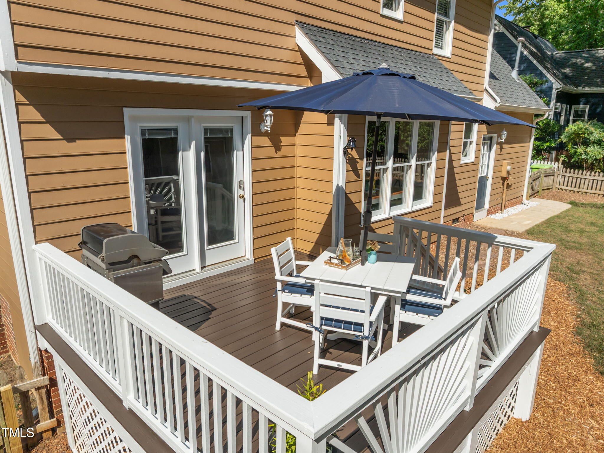 5909 Stable Court Raleigh, NC 27612 - Photo 37 of 45 a balcony of a house with wooden floor and outdoor seating