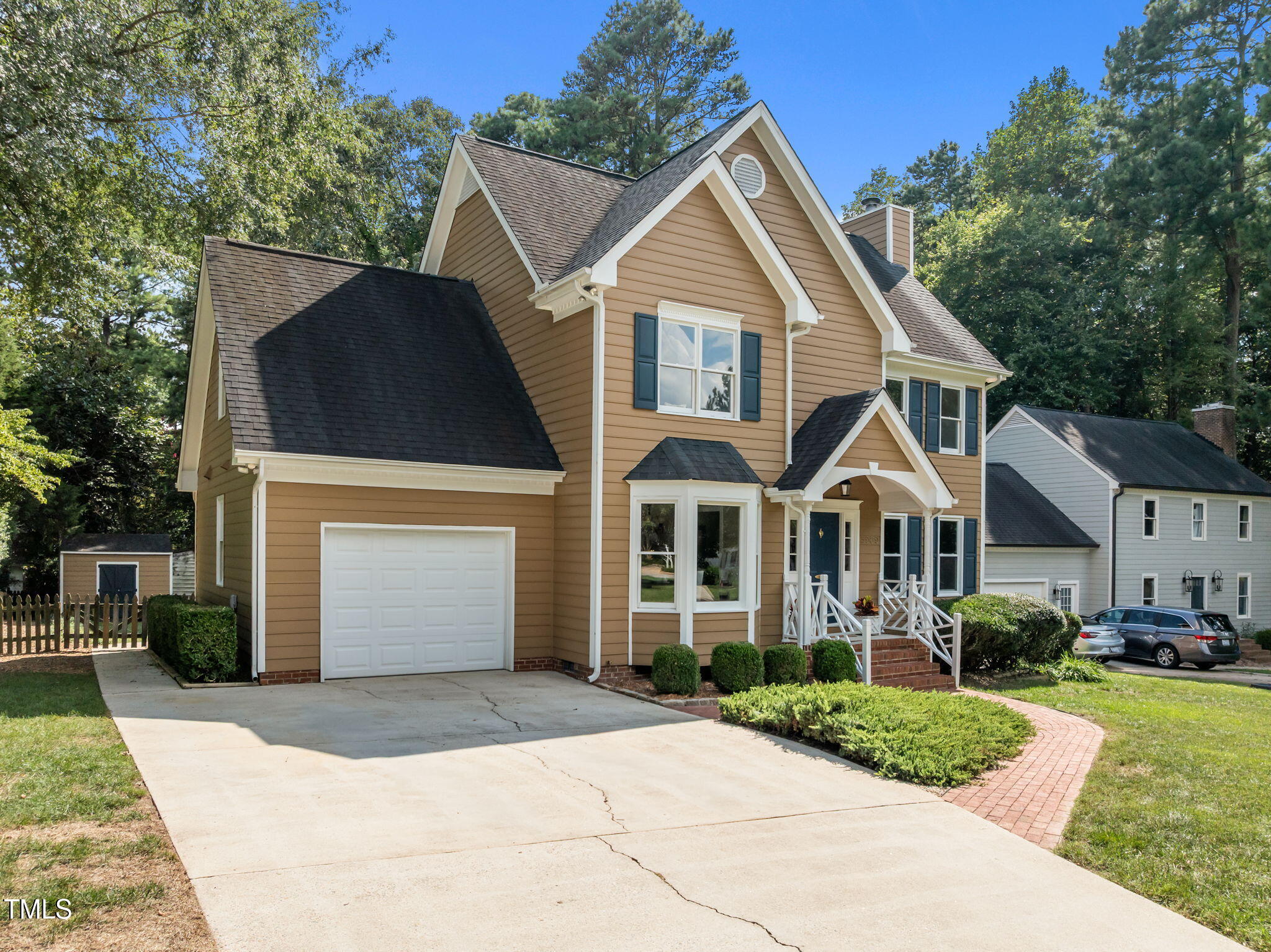 5909 Stable Court Raleigh, NC 27612 - Photo 42 of 45 a front view of a house with a yard and garage