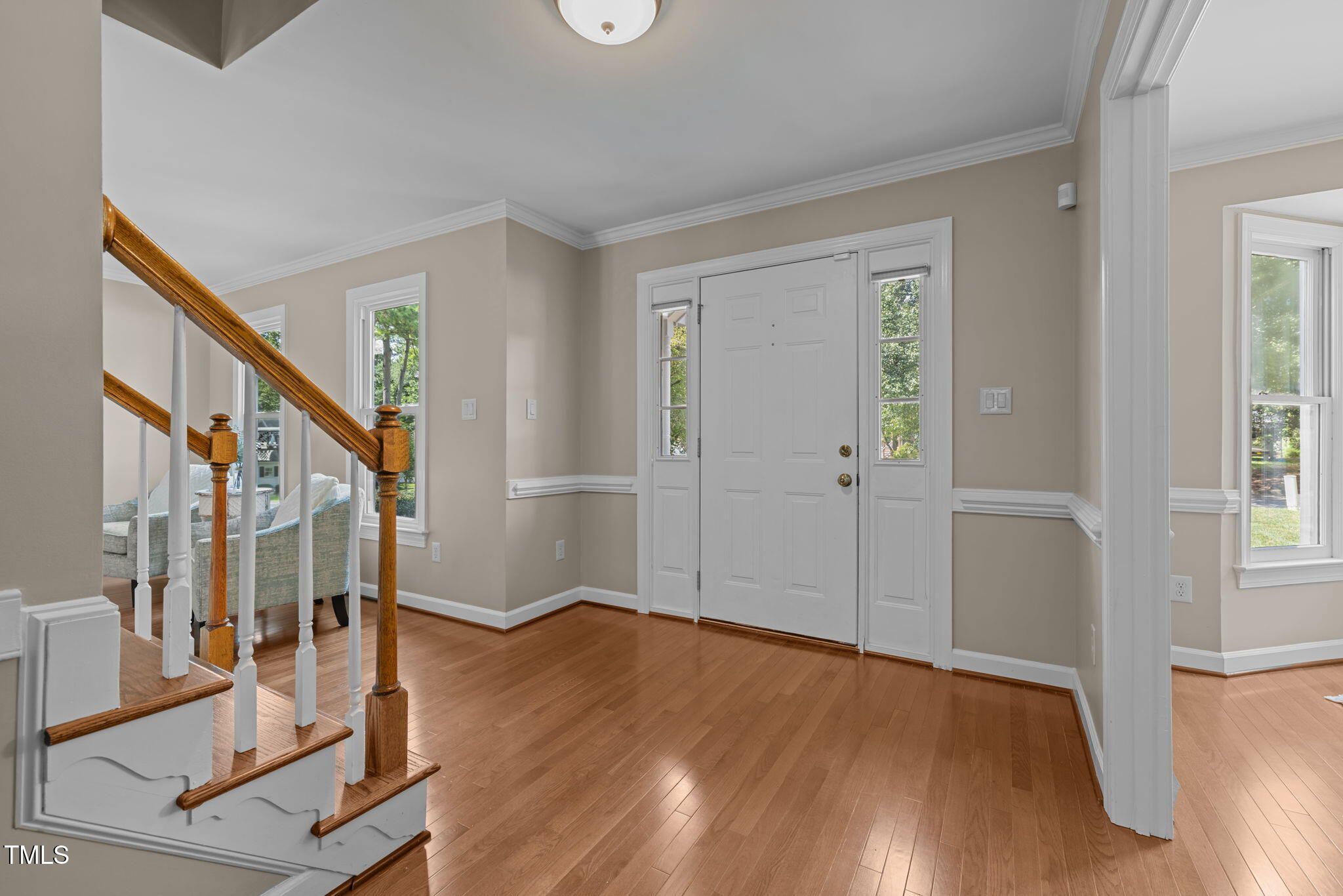 5909 Stable Court Raleigh, NC 27612 - Photo 6 of 45 a view of an entryway with wooden floor and stairs