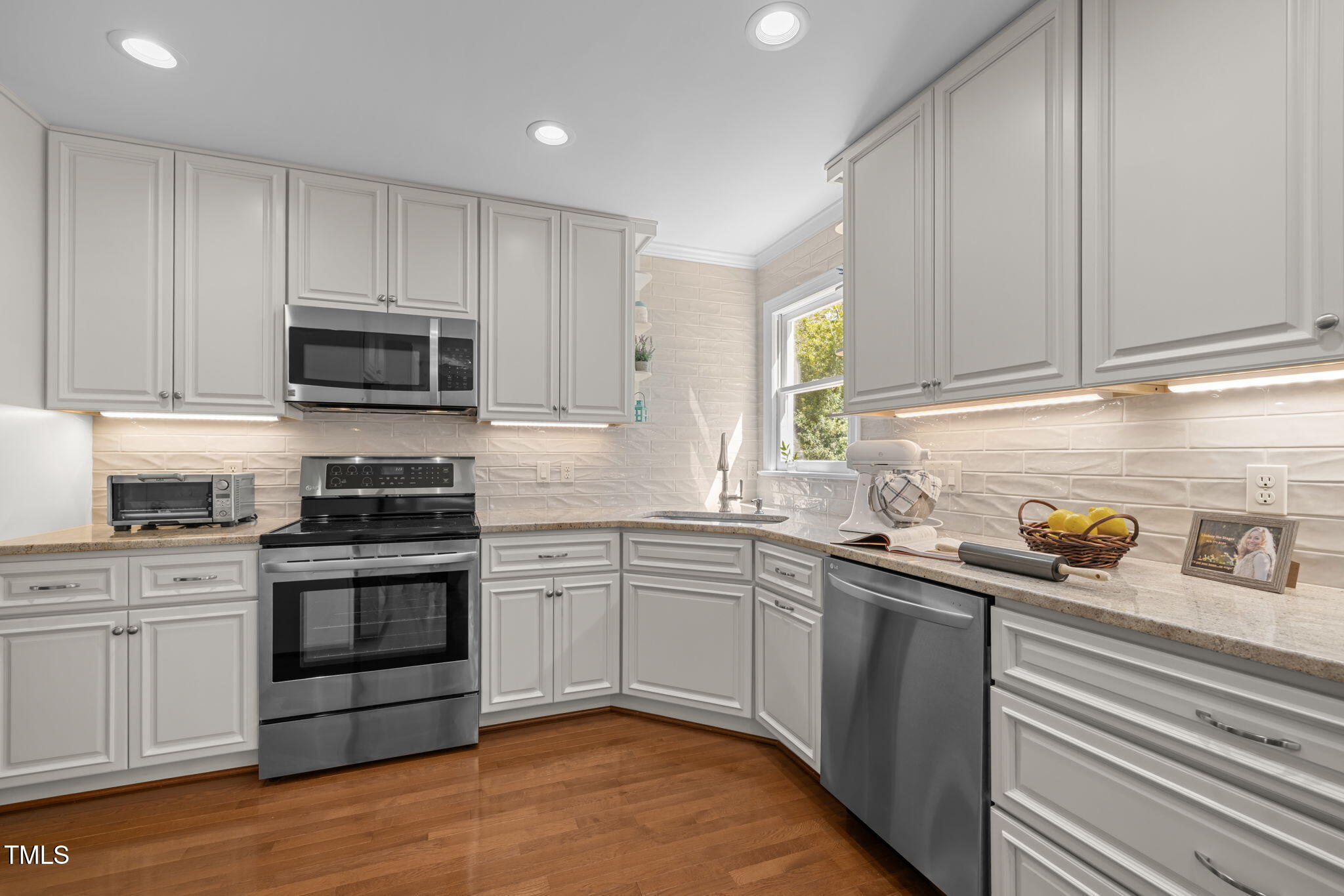 5909 Stable Court Raleigh, NC 27612 - Photo 9 of 45 a kitchen with stainless steel appliances granite countertop a stove a sink and a microwave