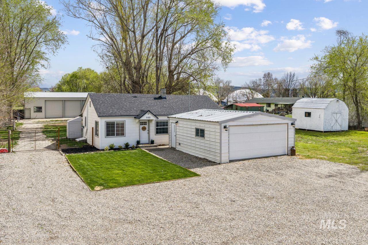 948 South Mill Road Emmett, ID 83617 - Photo 1 of 38 View of front facade featuring an outbuilding, a front lawn, and a garage