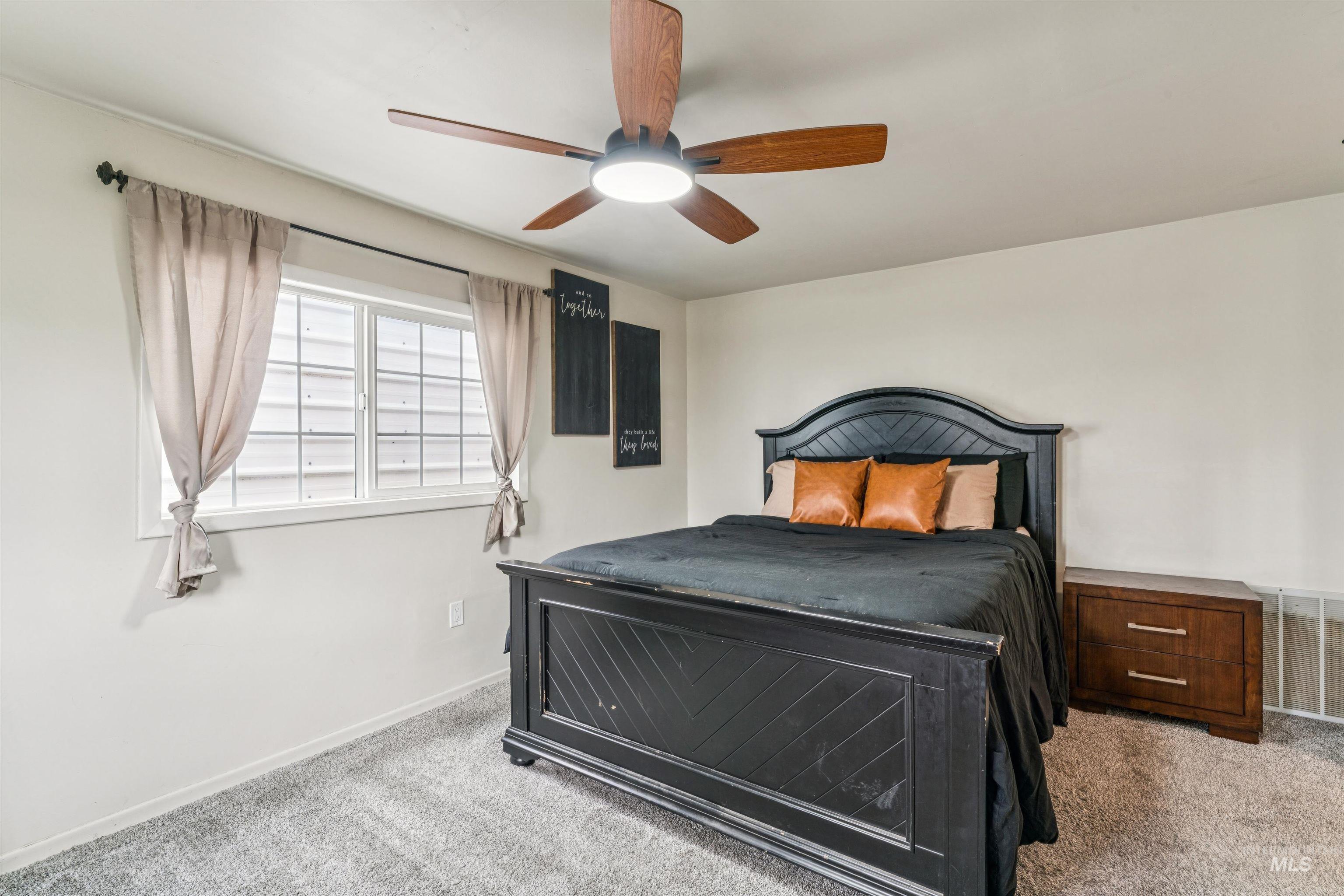 948 South Mill Road Emmett, ID 83617 - Photo 16 of 38 Carpeted bedroom featuring ceiling fan and baseboards