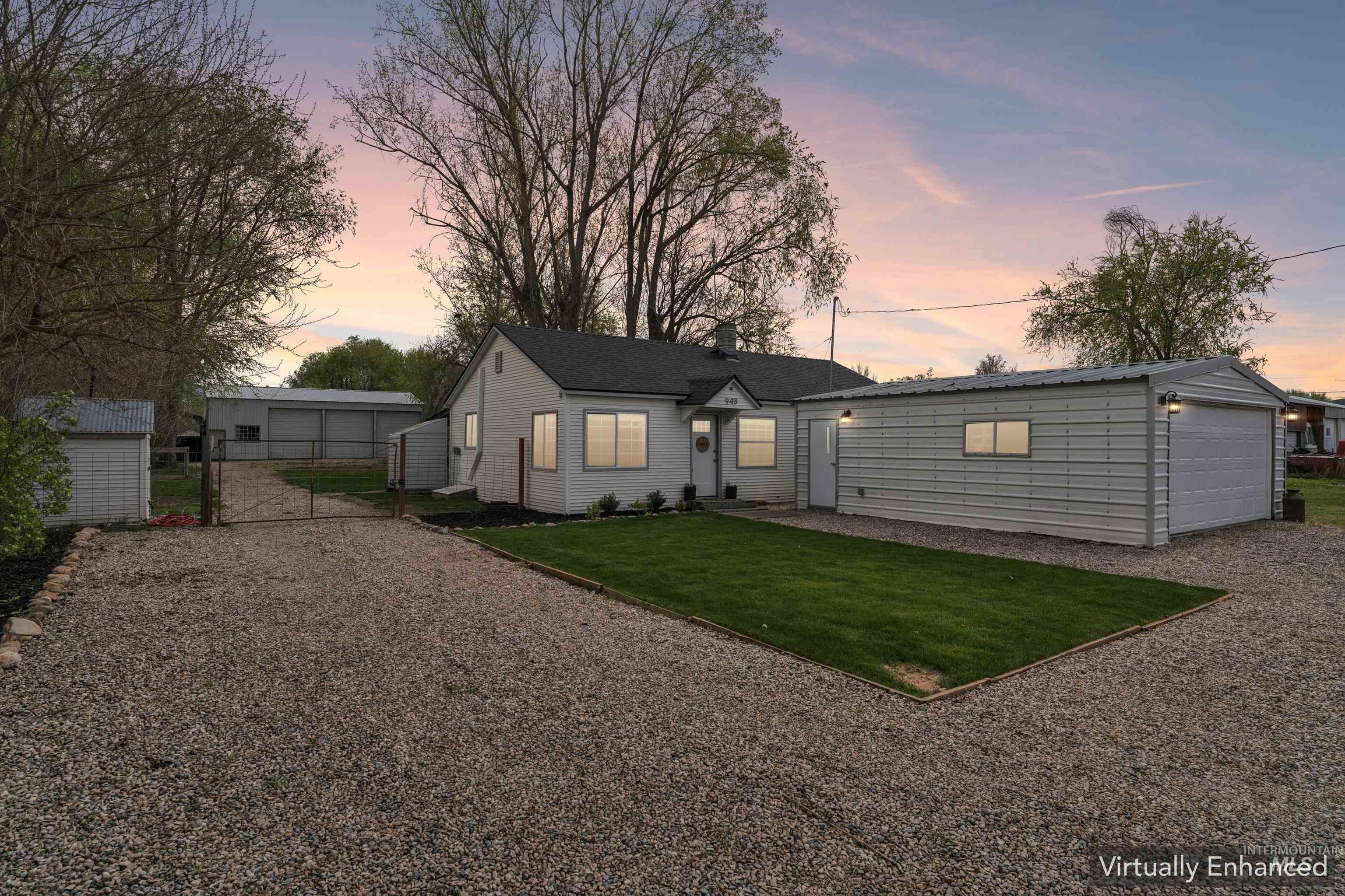948 South Mill Road Emmett, ID 83617 - Photo 2 of 38 View of front of property with an outdoor structure, a garage, a gate, and gravel driveway
