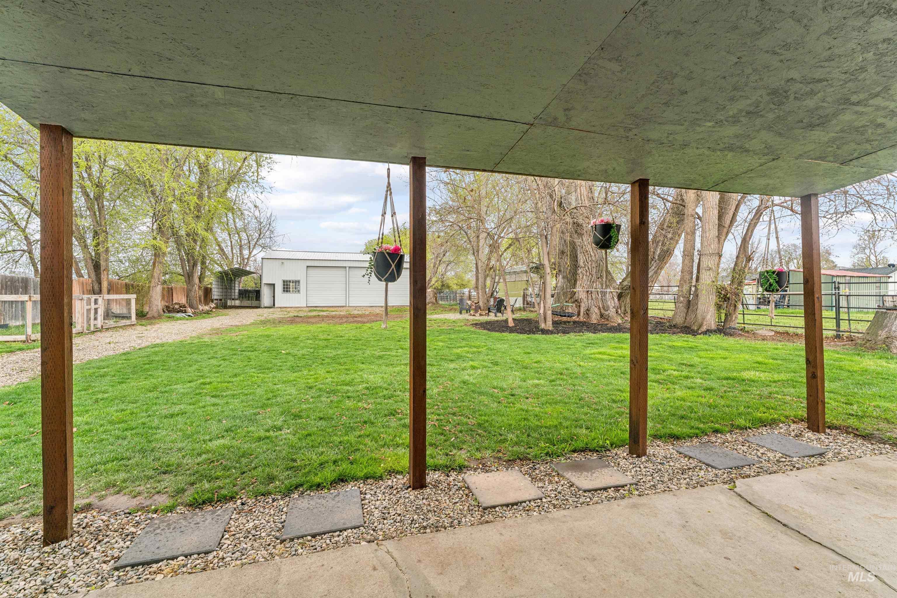 948 South Mill Road Emmett, ID 83617 - Photo 21 of 38 Fenced yard with a garage and an outdoor structure