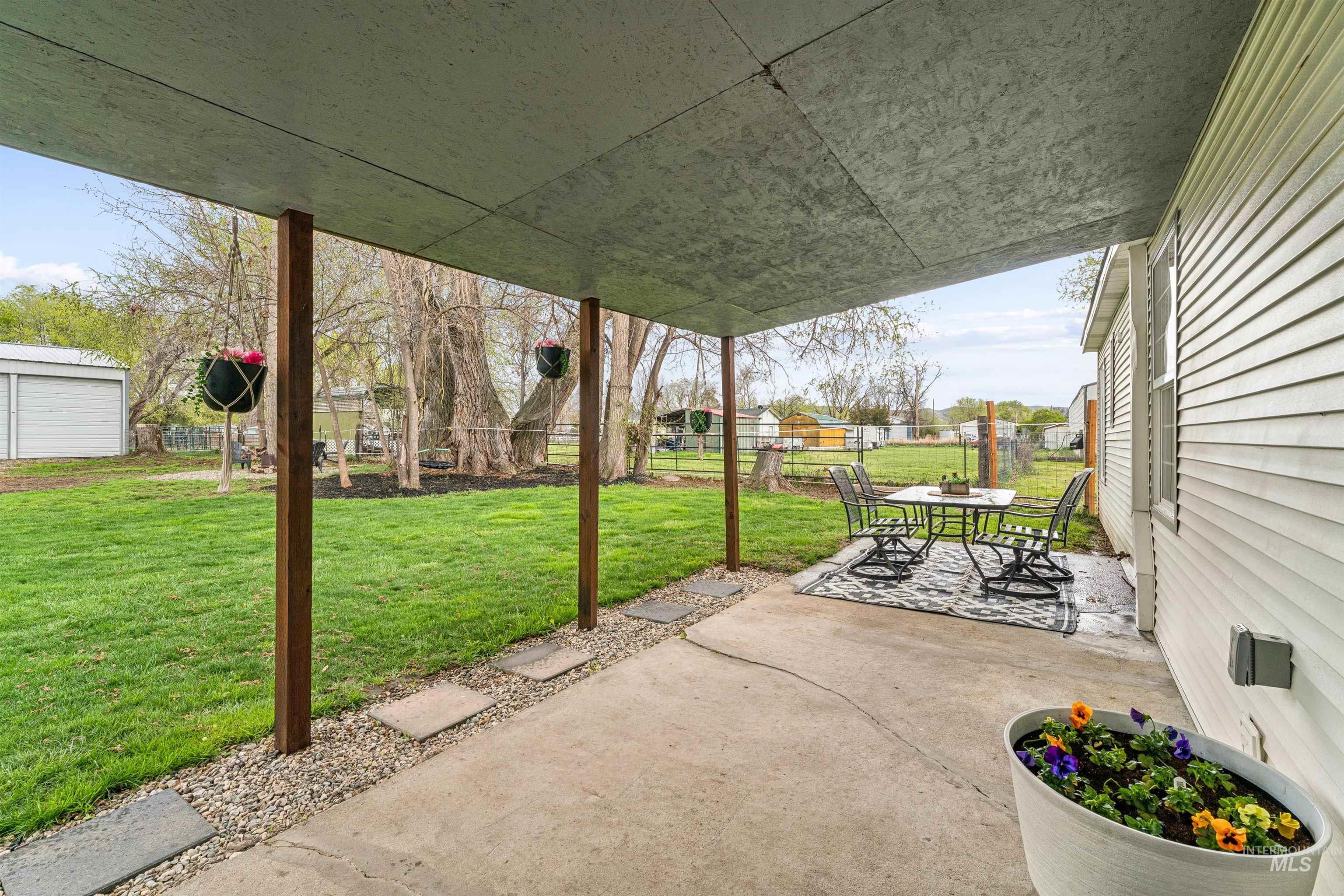 948 South Mill Road Emmett, ID 83617 - Photo 22 of 38 Fenced backyard with a patio and outdoor dining space