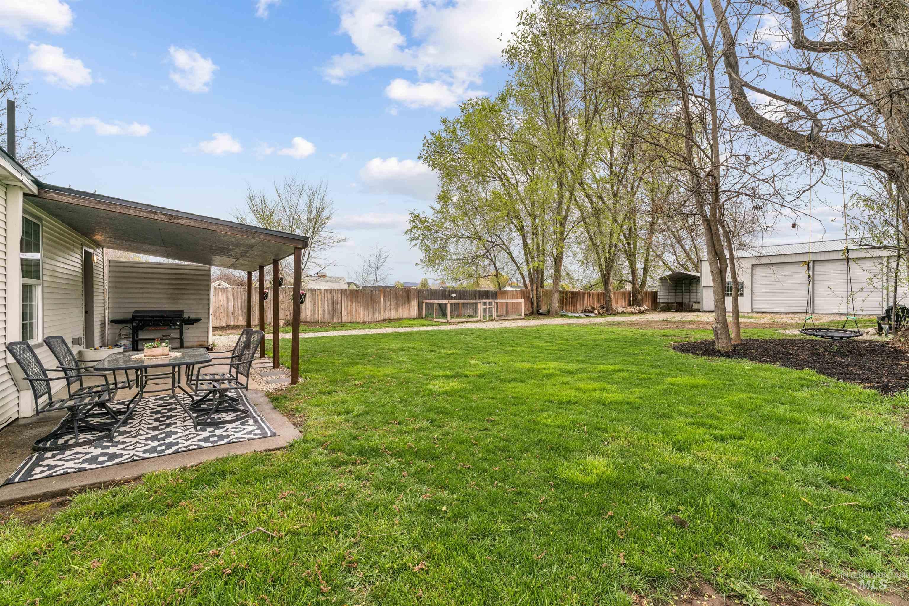 948 South Mill Road Emmett, ID 83617 - Photo 24 of 38 Fenced backyard with a patio and an outdoor structure