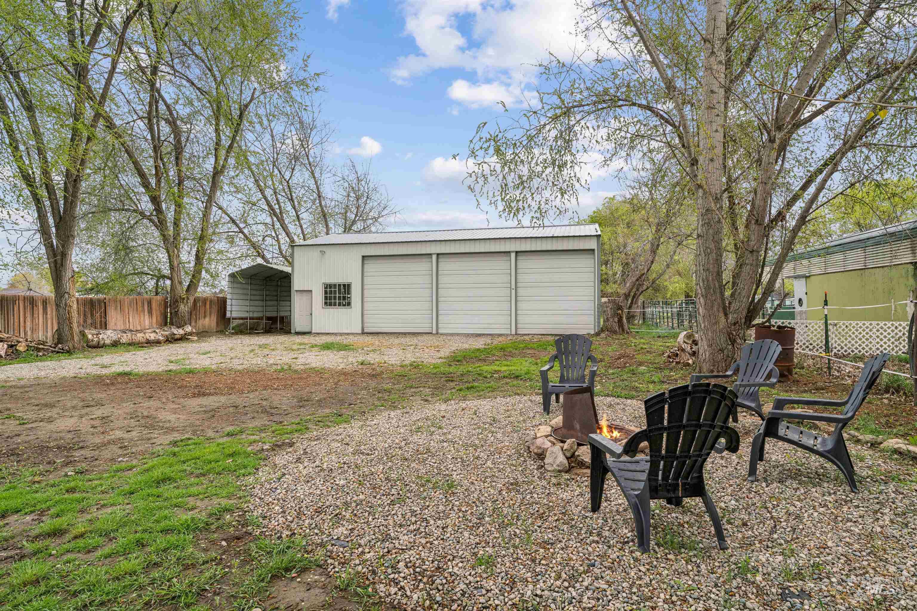 948 South Mill Road Emmett, ID 83617 - Photo 25 of 38 View of yard featuring a fire pit and an outbuilding