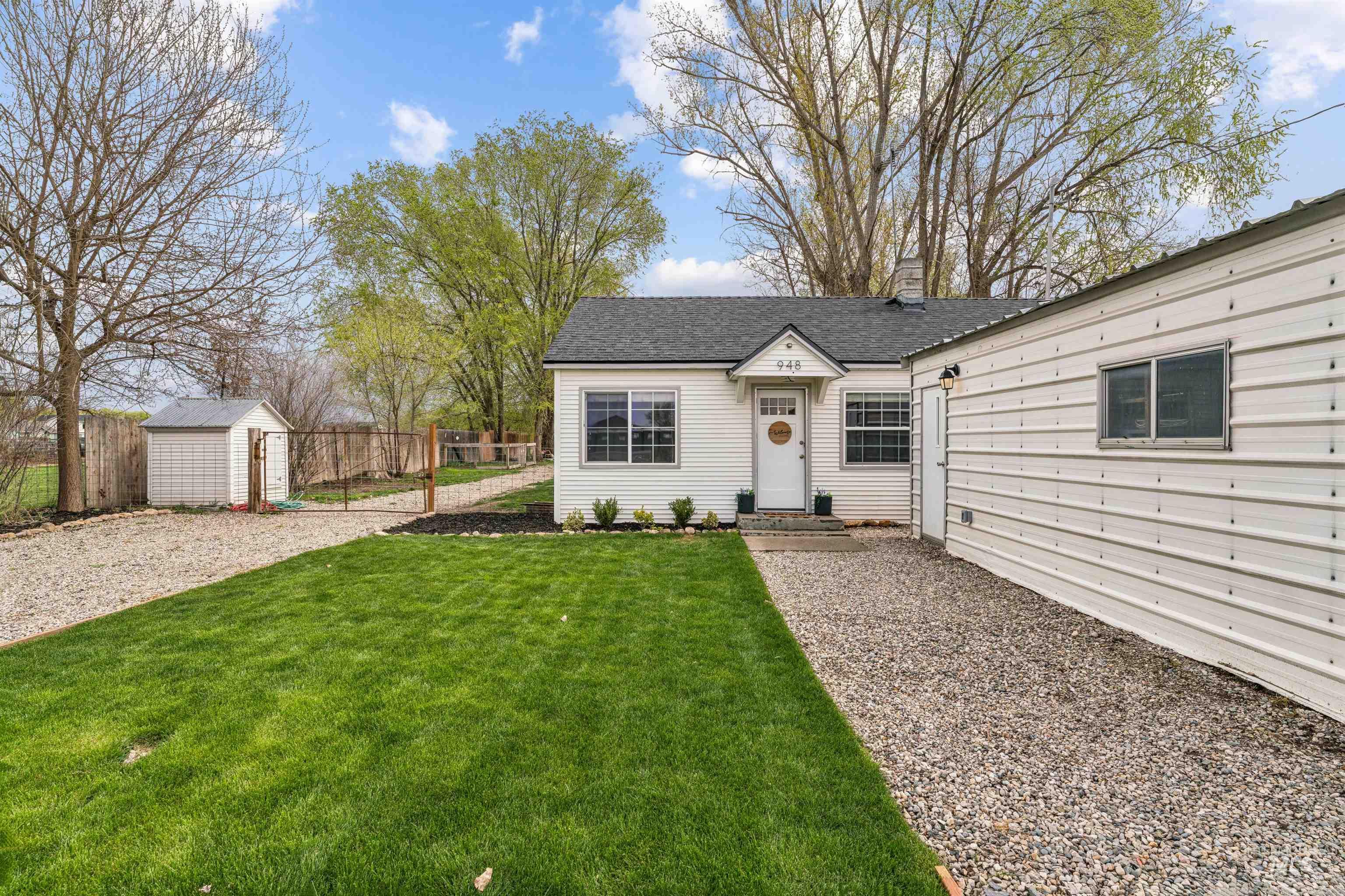 948 South Mill Road Emmett, ID 83617 - Photo 3 of 38 View of front of house featuring a chimney, roof with shingles, and a shed