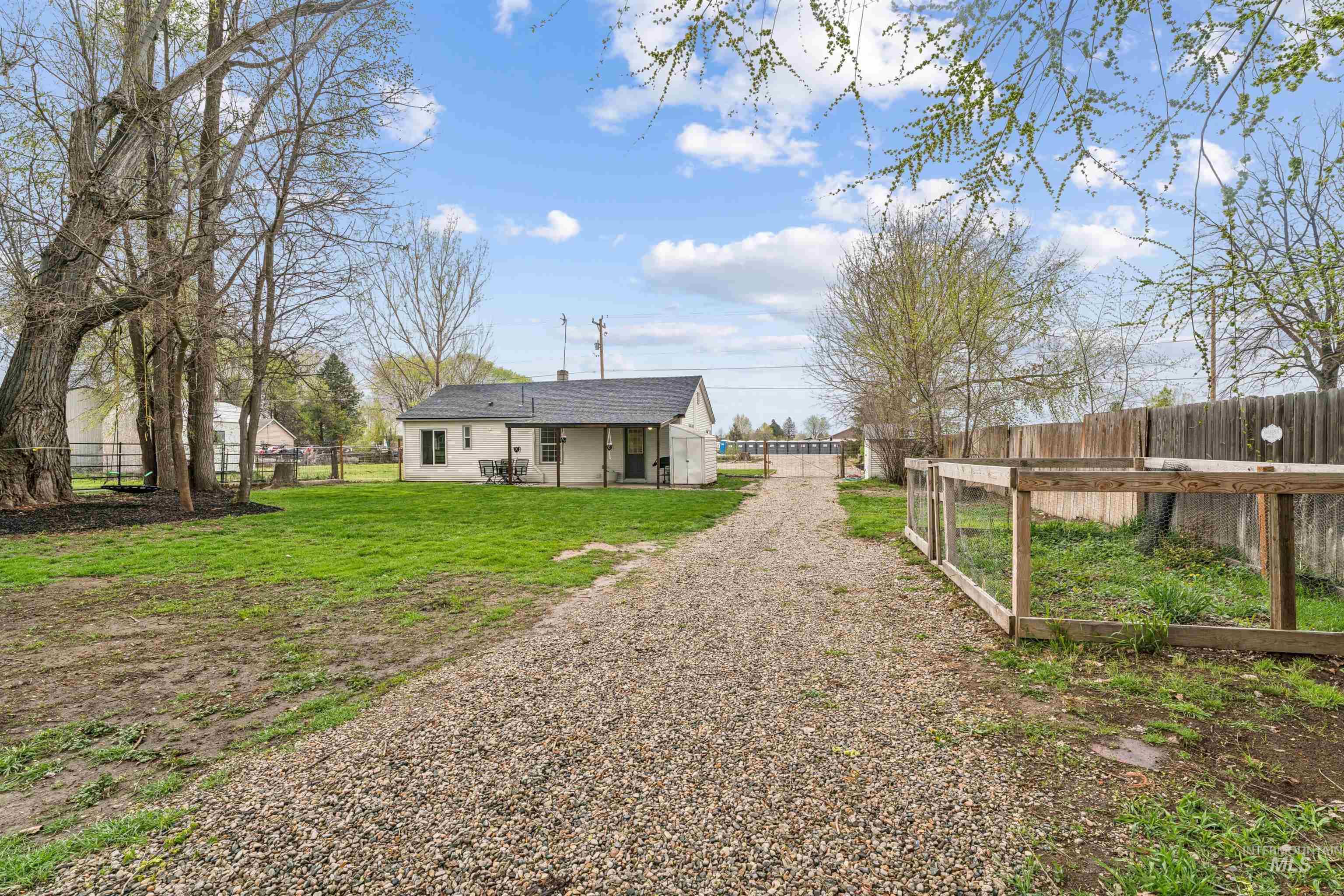 948 South Mill Road Emmett, ID 83617 - Photo 35 of 38 Rear view of house featuring a patio area and a fenced backyard