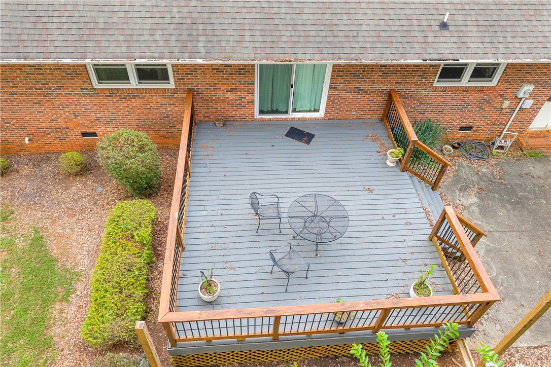 103 Colleton Court Clemson, SC 29631 - Photo 36 of 49 An elevated wood deck sits against a classic brick facade overlooking the backyard.