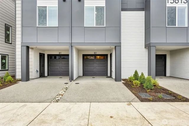 a view of room that has a large window and dresser