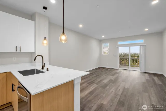 a living room with furniture or kitchen view and a potted plant