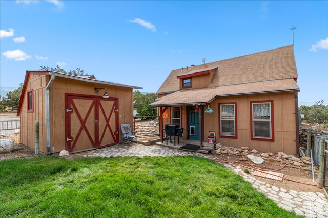 11450 Pigeon Hollow Road Spring City, UT 84662 - Photo 20 of 47 Rear view of property with a patio, a storage shed, and a shingled roof