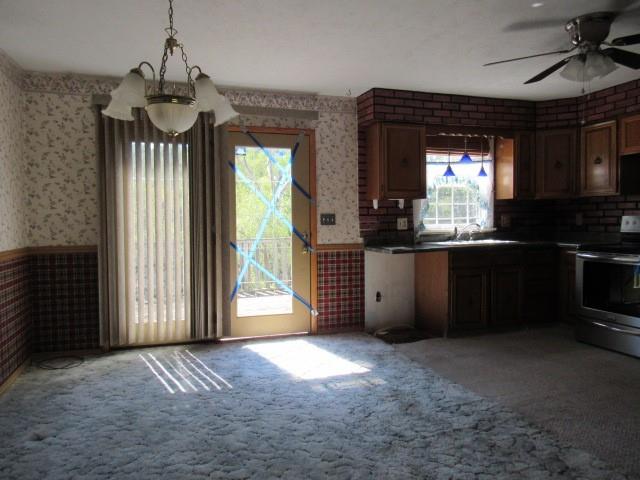 300 Stone Church Road Grindstone, PA 15442 - Photo 7 of 18 a view of a kitchen with a fridge and wooden floor