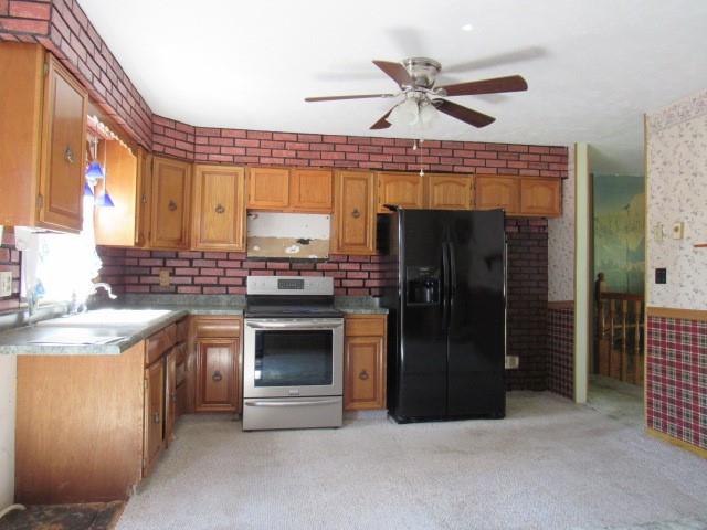 300 Stone Church Road Grindstone, PA 15442 - Photo 8 of 18 a kitchen with stainless steel appliances granite countertop a stove a refrigerator and a sink