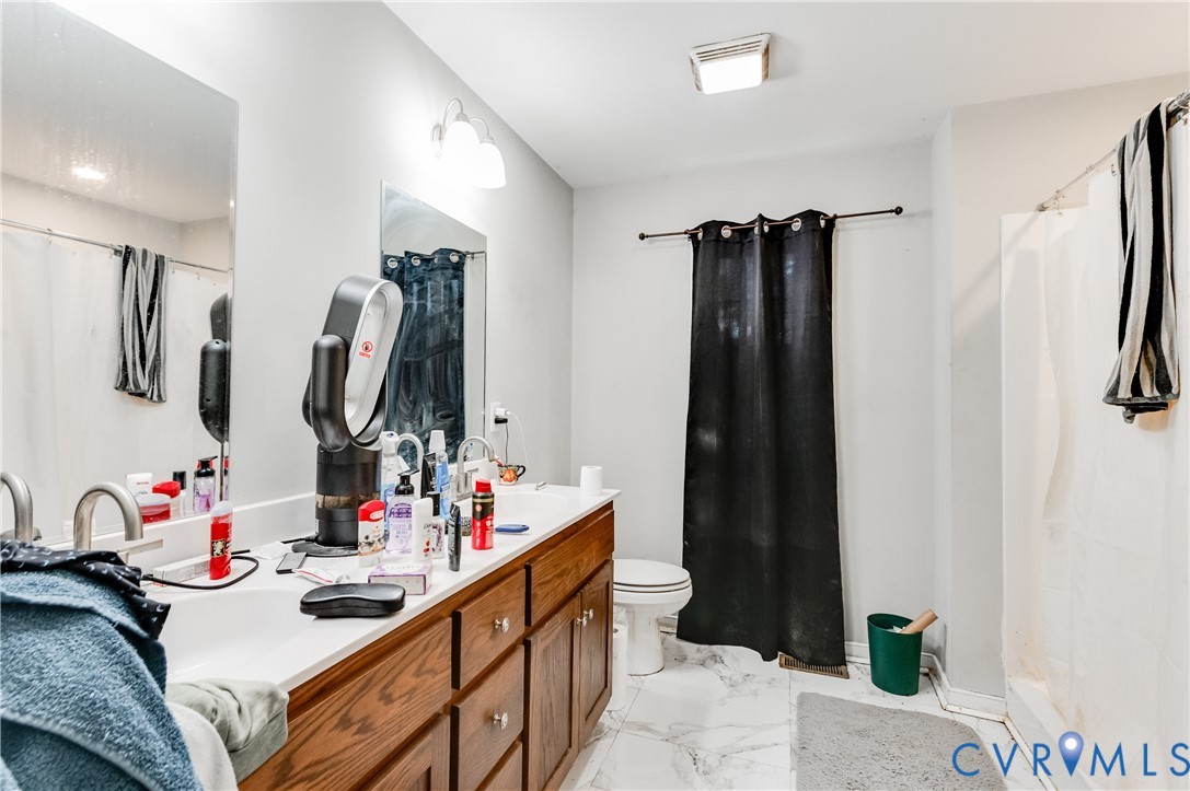 24580 St James Road Jetersville, VA 23083 - Photo 15 of 25 Bathroom featuring a dual vanity with a white coun