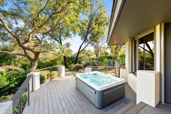 a bathroom with a granite countertop sink a toilet a mirror and shower