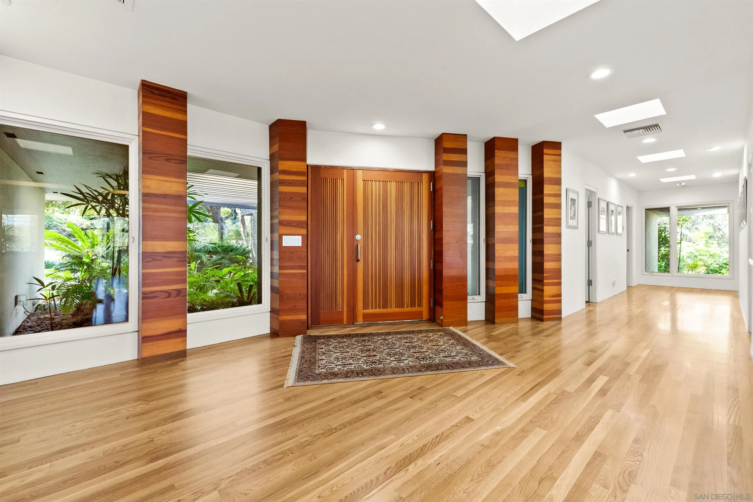 5491 Calzada Del Bosque Rancho Santa Fe, CA 92067 - Photo 34 of 69 a view of a room with wooden floor and a large window