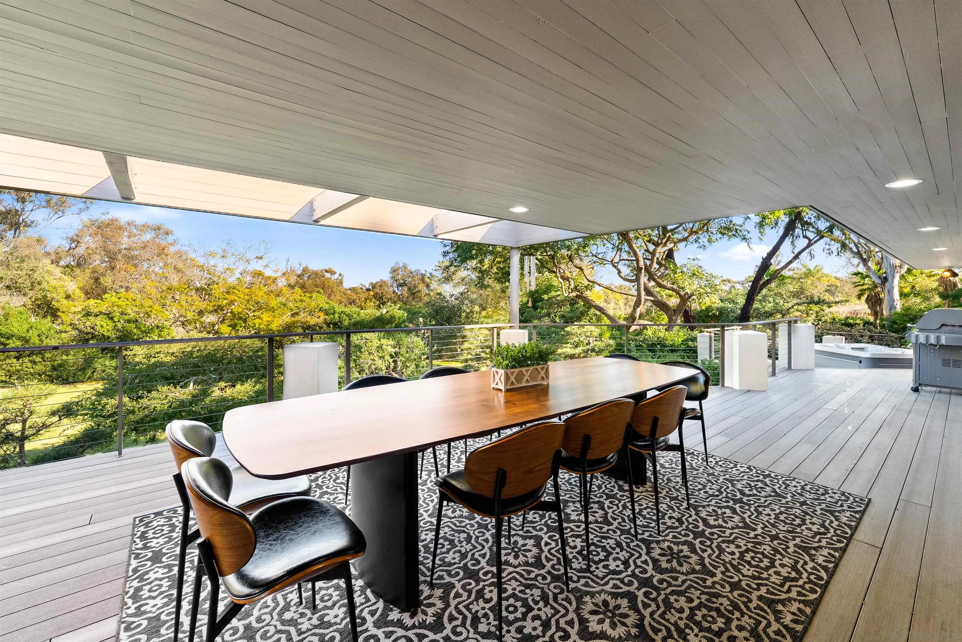 5491 Calzada Del Bosque Rancho Santa Fe, CA 92067 - Photo 36 of 69 a view of a patio with table and chairs with wooden floor and fence