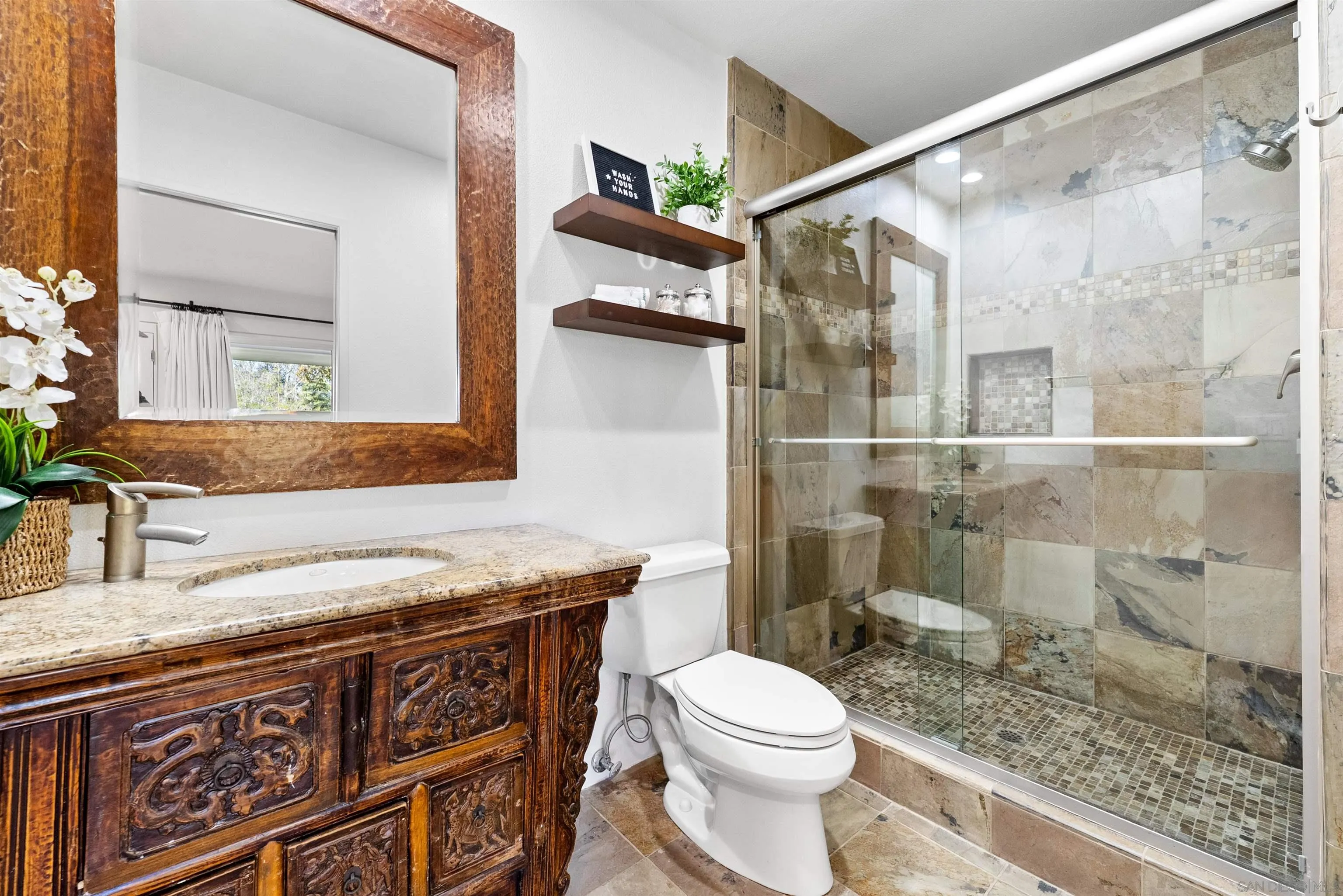 5491 Calzada Del Bosque Rancho Santa Fe, CA 92067 - Photo 46 of 69 a bathroom with a granite countertop sink a toilet a mirror and shower