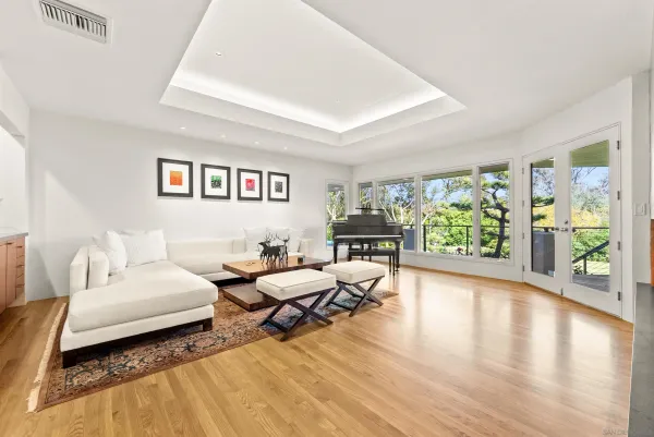 a large kitchen with stainless steel appliances a large counter top a stove a chimney a sink and a refrigerator