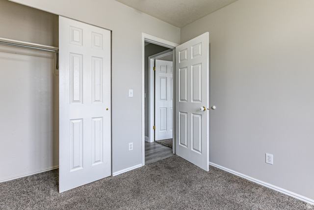 4239 West 5325th Street South Roy, UT 84067 - Photo 14 of 26 Neutral-toned room featuring a soft carpeted floor and light gray walls