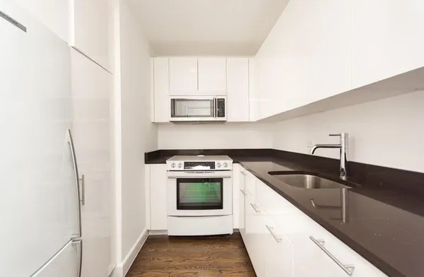 a kitchen with a sink and a refrigerator