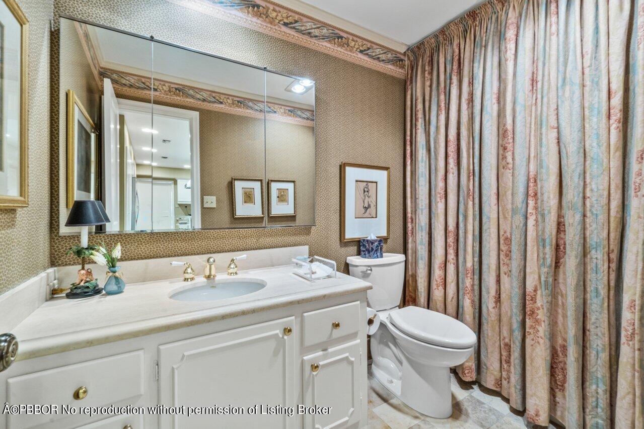 355 Cocoanut Row, Unit 2 Palm Beach, FL 33480 - Photo 11 of 26 a bathroom with a toilet a sink and a large mirror