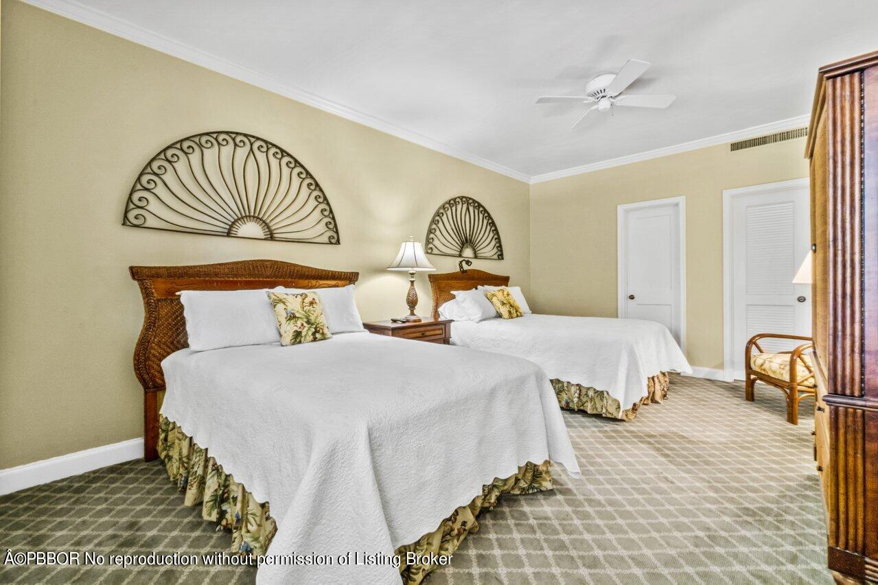 355 Cocoanut Row, Unit 2 Palm Beach, FL 33480 - Photo 13 of 26 a bedroom with a bed and a table