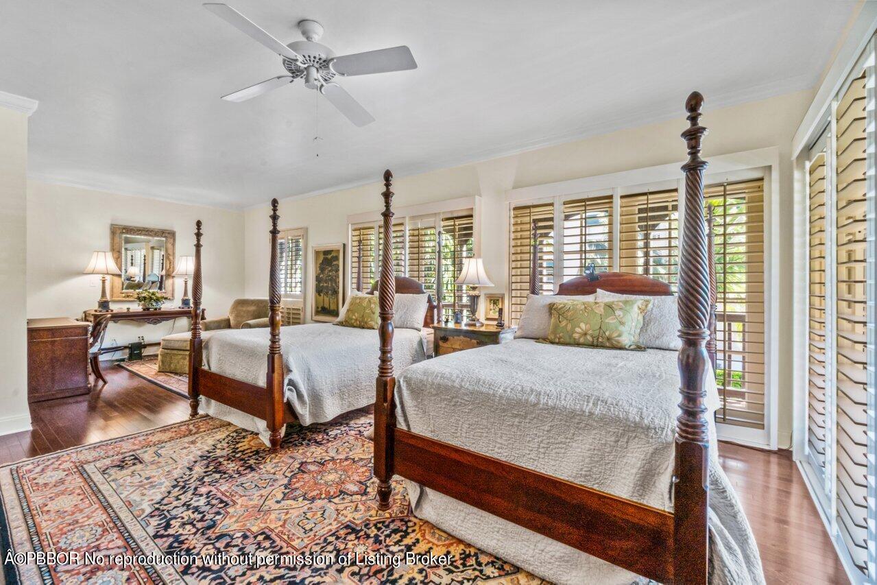355 Cocoanut Row, Unit 2 Palm Beach, FL 33480 - Photo 16 of 26 a spacious bedroom with a bed a table and large windows