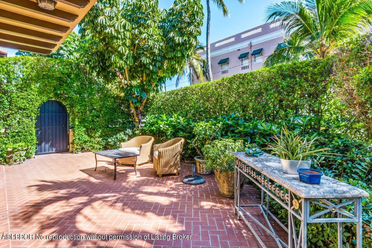 355 Cocoanut Row, Unit 2 Palm Beach, FL 33480 - Photo 23 of 26 a backyard of a house with wooden floor and outdoor seating