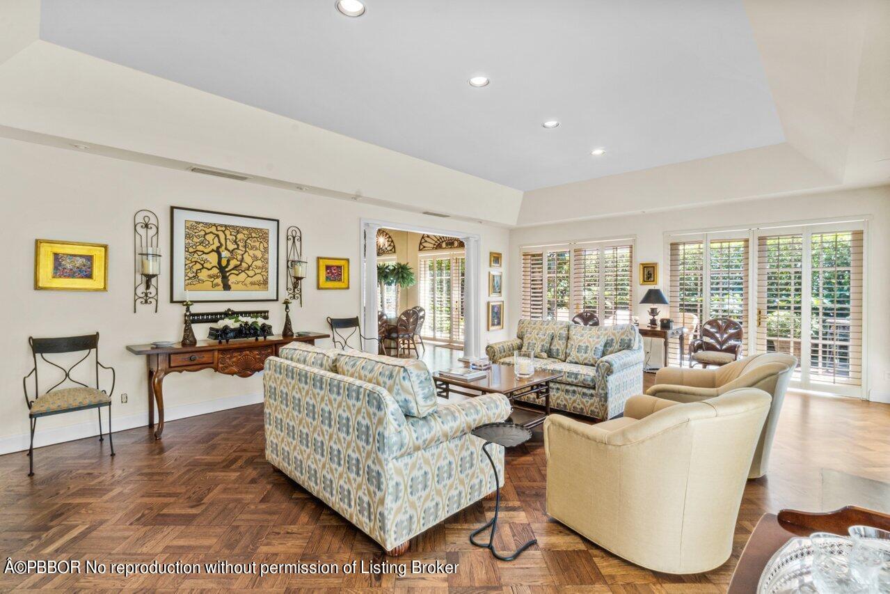 355 Cocoanut Row, Unit 2 Palm Beach, FL 33480 - Photo 7 of 26 a living room with furniture potted plant and large windows