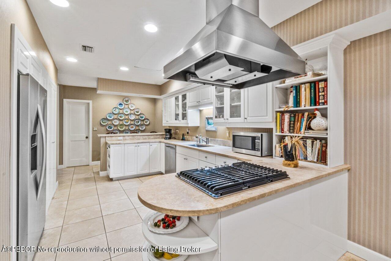 355 Cocoanut Row, Unit 2 Palm Beach, FL 33480 - Photo 9 of 26 a kitchen with a stove and a refrigerator