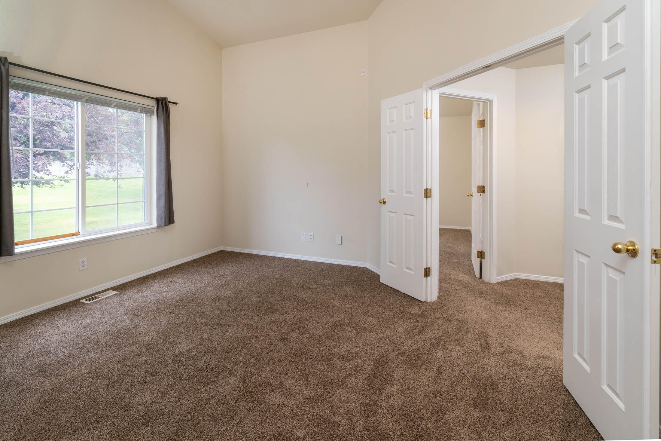 3389 Northeast Stonebrook Loop Bend, OR 97701 - Photo 18 of 27 Primary bedroom with view to rear of back lawn