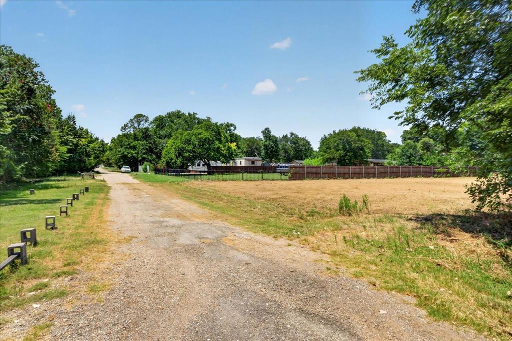 1306 Ranch Road Grand Prairie, TX 75052 - Photo 1 of 13 Expansive open lot with a partial wood privacy fence