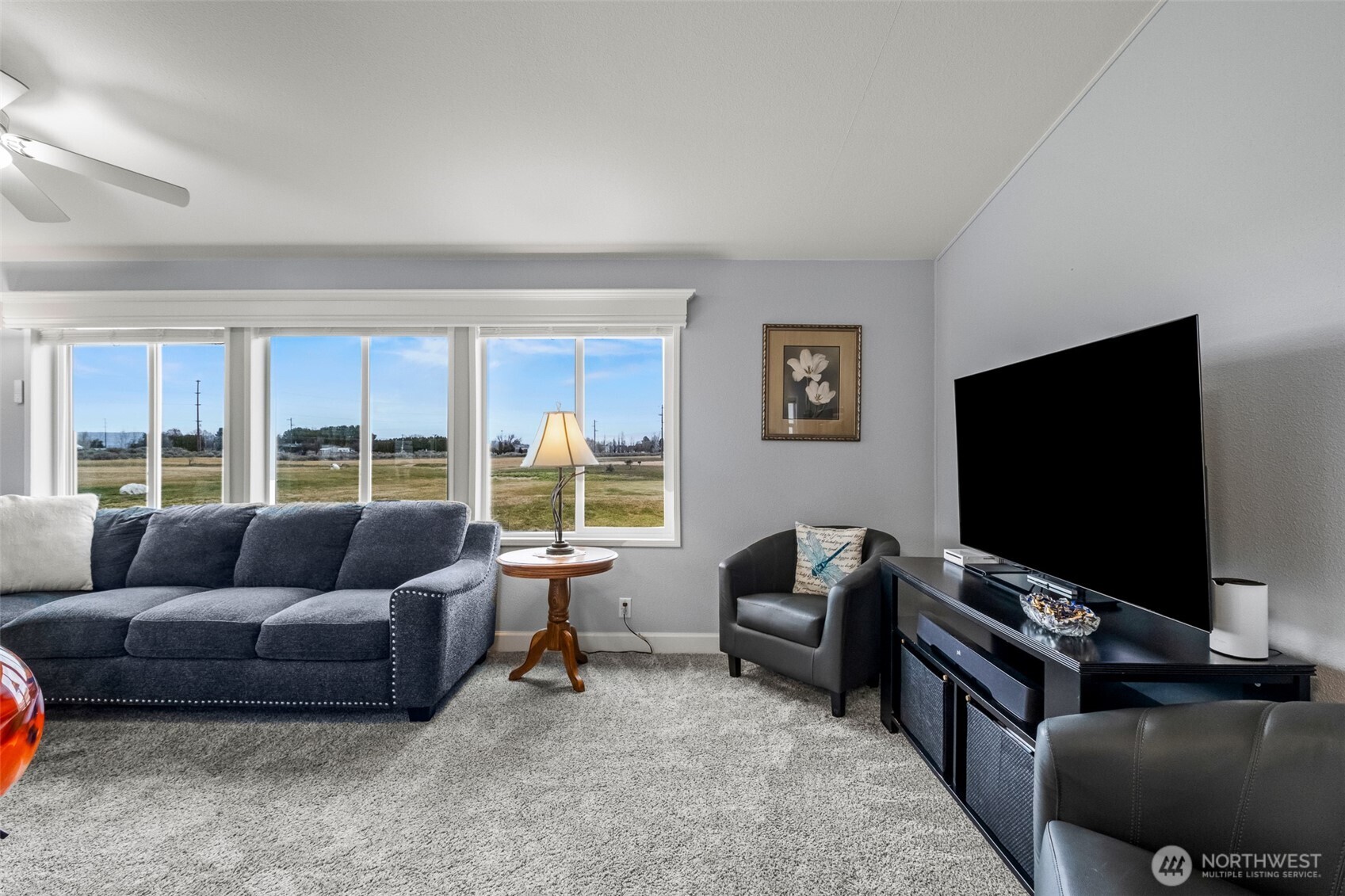 17693 Road 5 Northwest, Unit 52 Quincy, WA 98848 - Photo 13 of 25 a living room with furniture and a flat screen tv