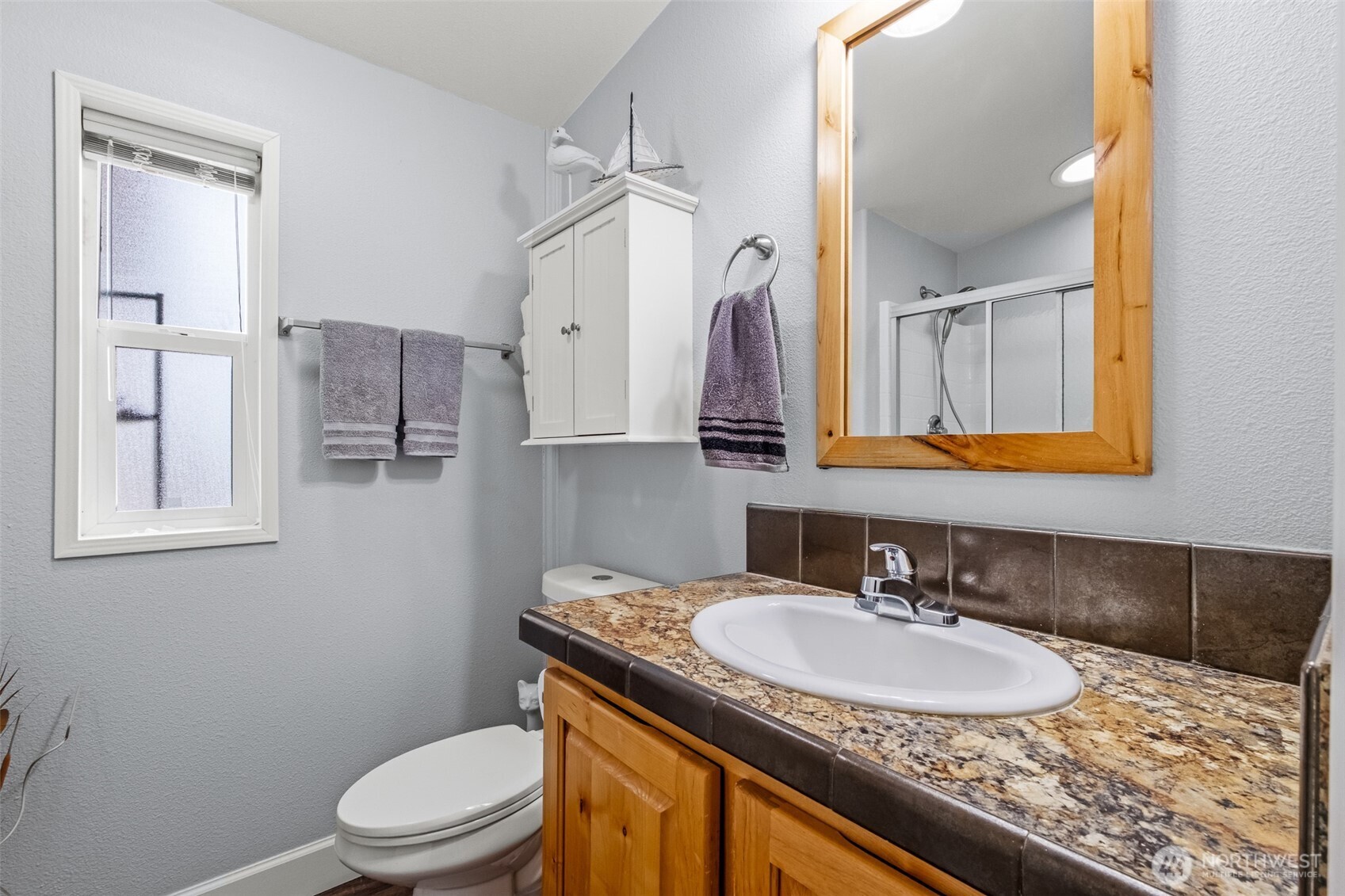 17693 Road 5 Northwest, Unit 52 Quincy, WA 98848 - Photo 19 of 25 a bathroom with a granite countertop sink toilet a mirror and shower