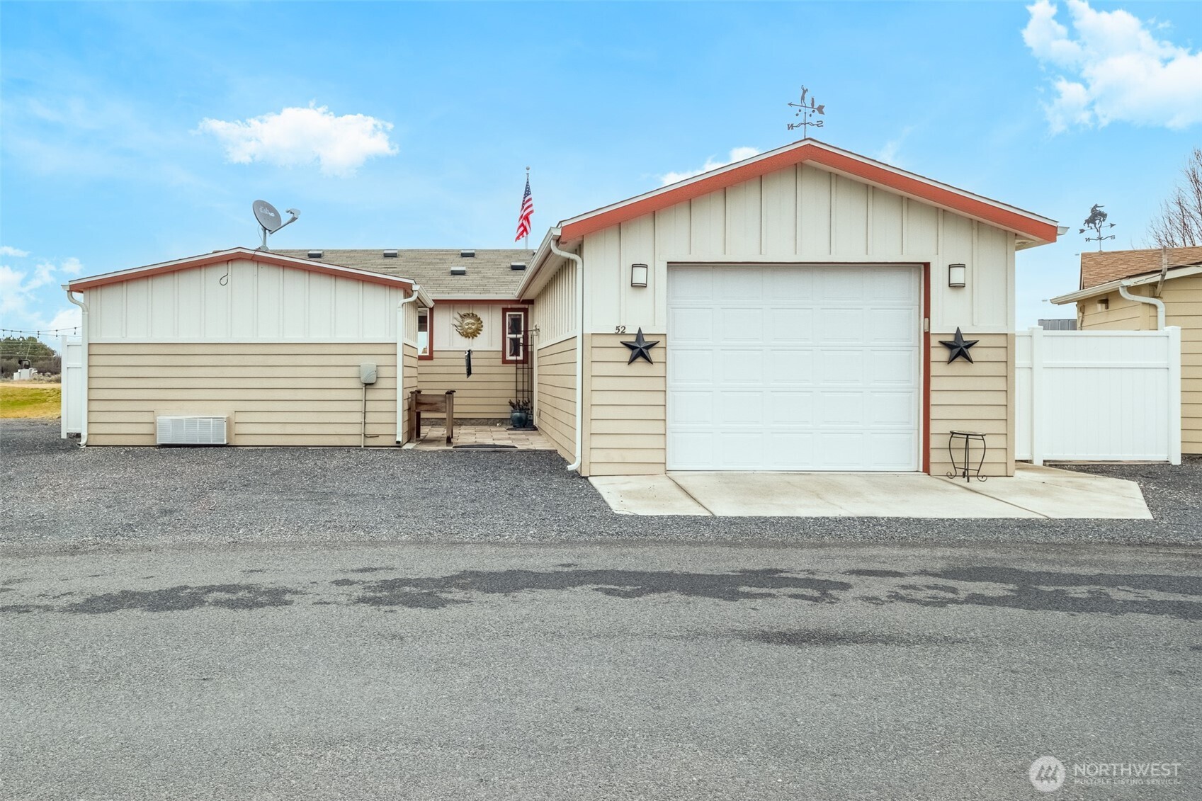 17693 Road 5 Northwest, Unit 52 Quincy, WA 98848 - Photo 3 of 25 a front view of a house with a yard and garage