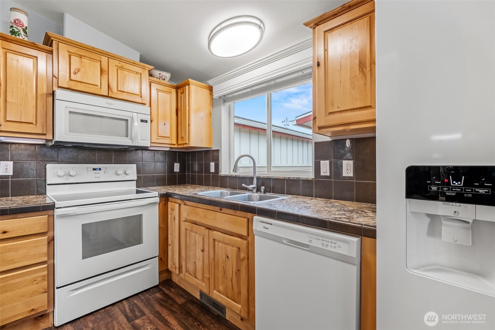 17693 Road 5 Northwest, Unit 52 Quincy, WA 98848 - Photo 9 of 25 a kitchen with granite countertop a sink a stove and cabinets