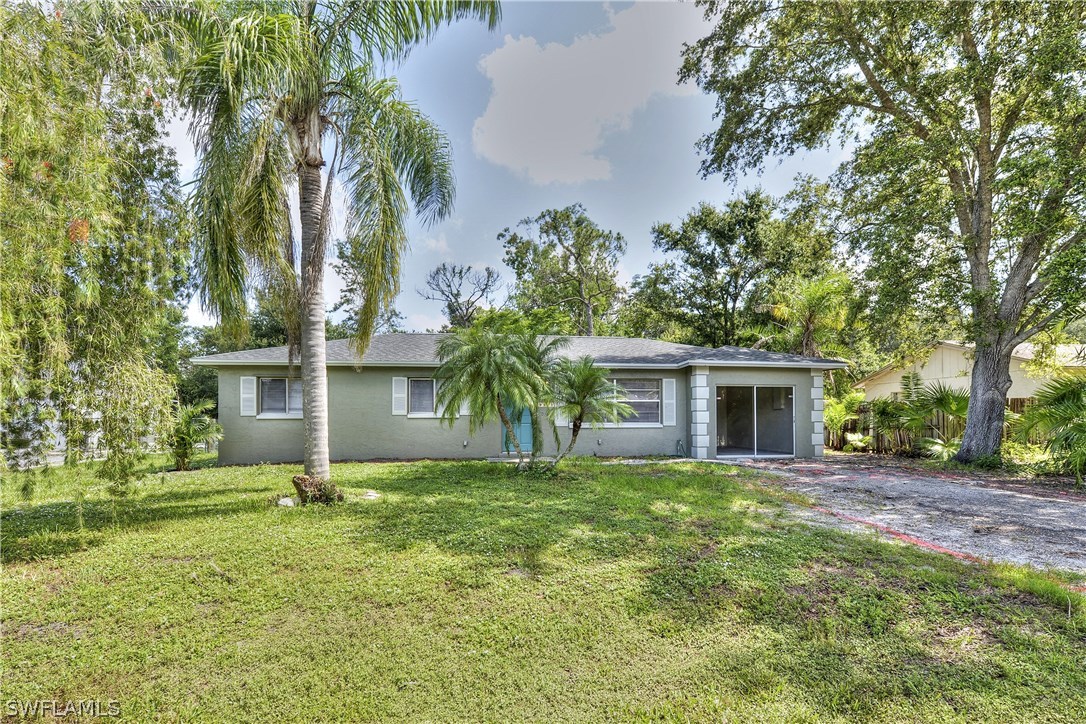 9321 Sedgefield Road North Fort Myers, FL 33917 - Photo 1 of 26 a house that has a tree in front of the house