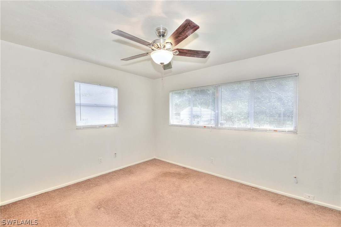 9321 Sedgefield Road North Fort Myers, FL 33917 - Photo 14 of 26 an empty room with a window and a fan