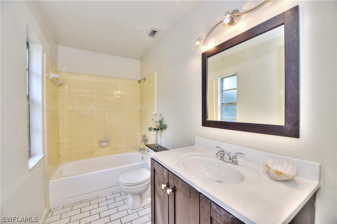 9321 Sedgefield Road North Fort Myers, FL 33917 - Photo 17 of 26 a bathroom with a sink a toilet and shower