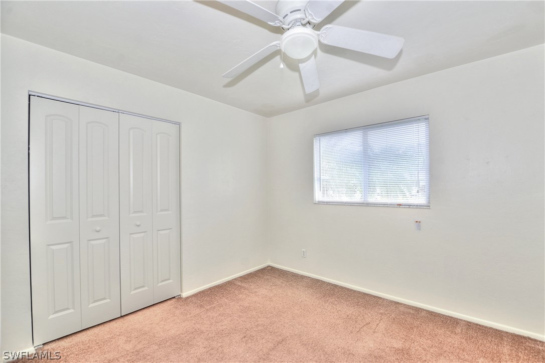 9321 Sedgefield Road North Fort Myers, FL 33917 - Photo 18 of 26 an empty room with a window and a fan