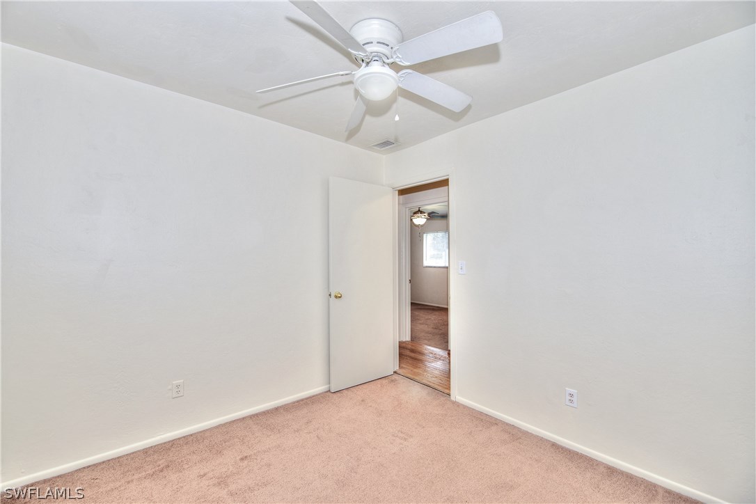 9321 Sedgefield Road North Fort Myers, FL 33917 - Photo 19 of 26 an empty room with a ceiling fan and a ceiling fan